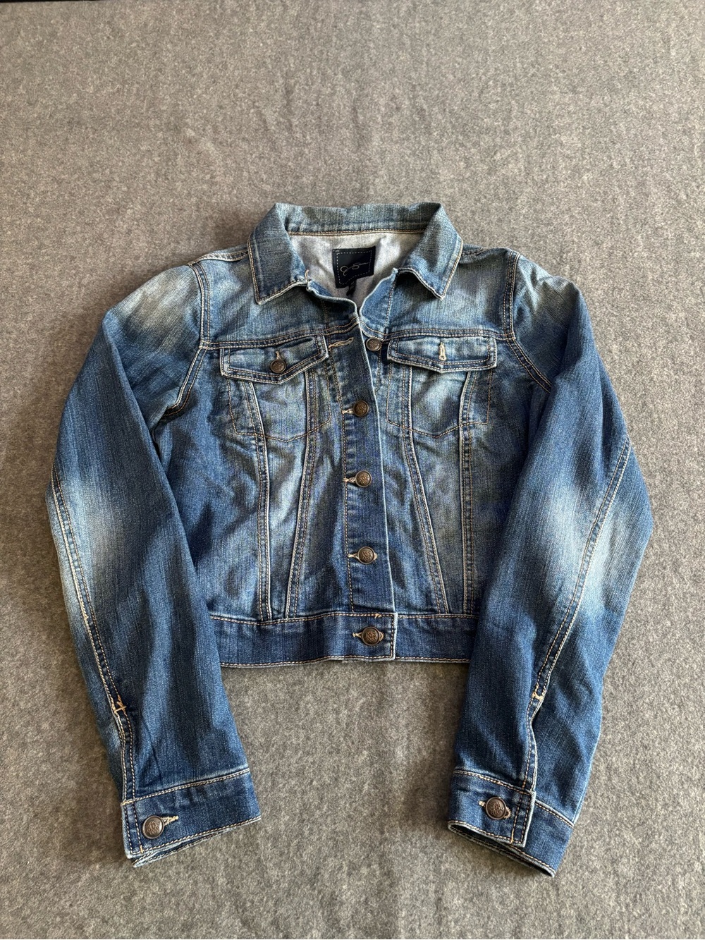 Jessica Simpson Blue denim jacket with a faded wash size Medium